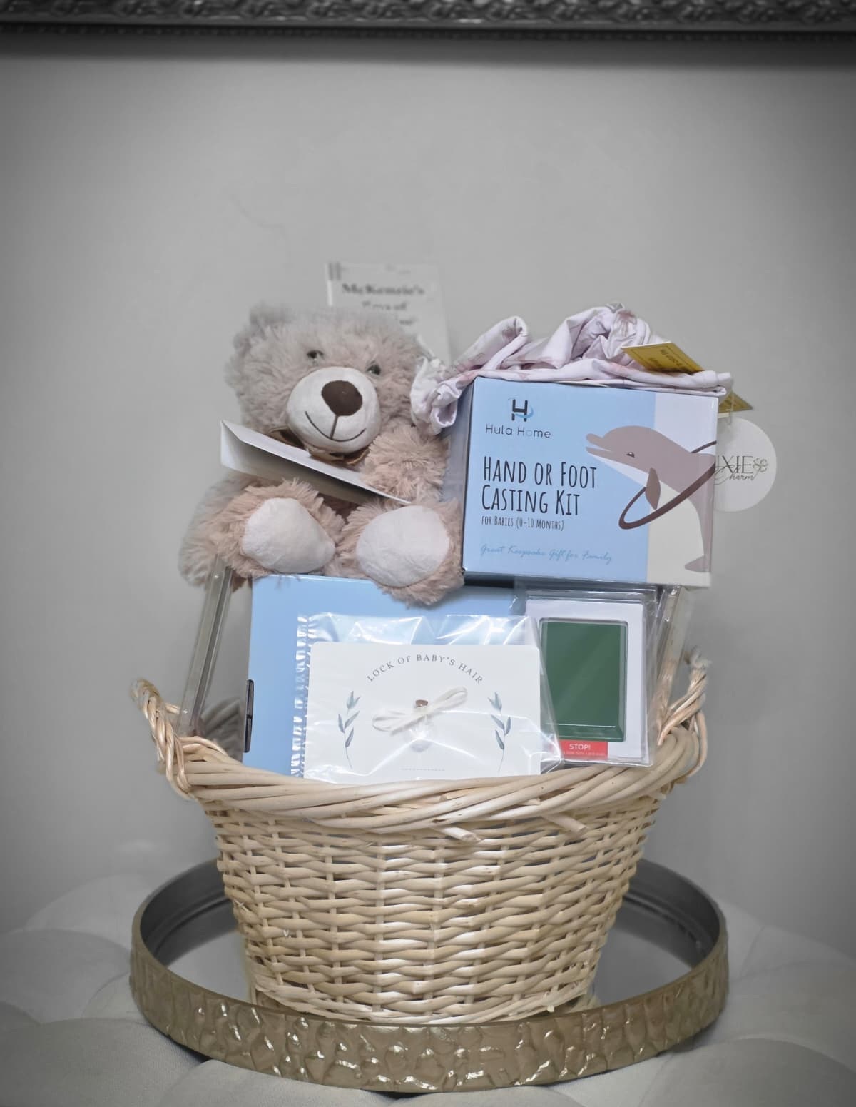 A memory-making kit: a keepsake basket with a comfort bear, hand and foot casting kit, and a lock-of-hair keepsake